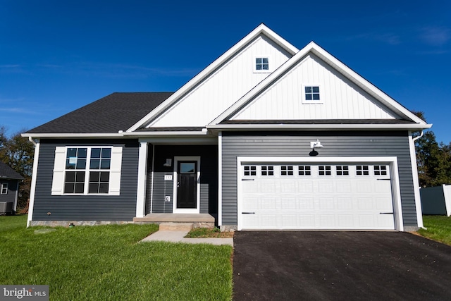 view of front of property featuring a front yard and a garage