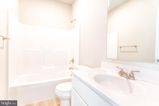 full bathroom with hardwood / wood-style floors, vanity, toilet, and bathing tub / shower combination