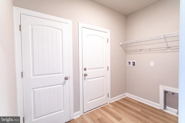 laundry room with wood-type flooring and hookup for a washing machine