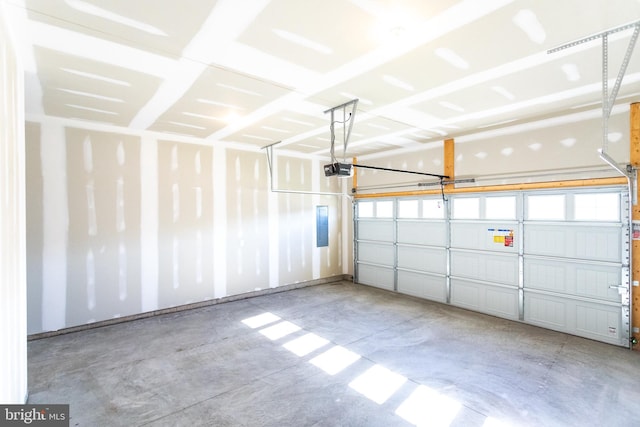 garage featuring electric panel and a garage door opener