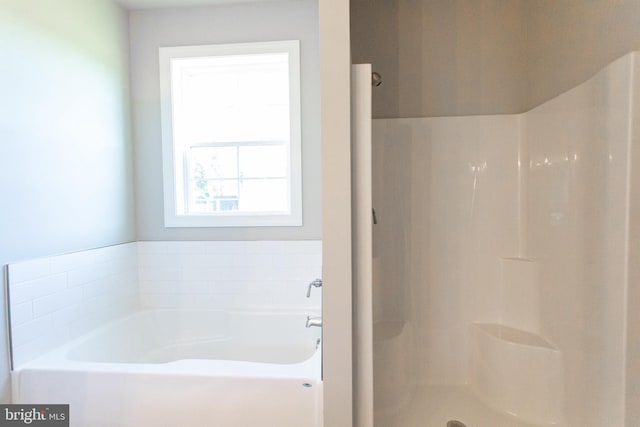 bathroom featuring a tub to relax in