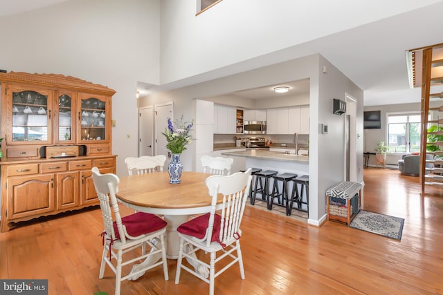 409 Hilltop Rd, Strasburg, PA 17579 - dining room featuring sink, light wood-type flooring, and a high ceiling