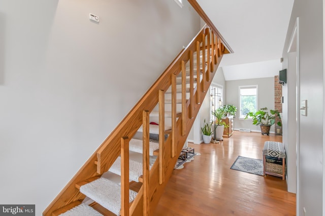409 Hilltop Rd, Strasburg, PA 17579 - stairway with light hardwood / wood-style flooring and brick wall