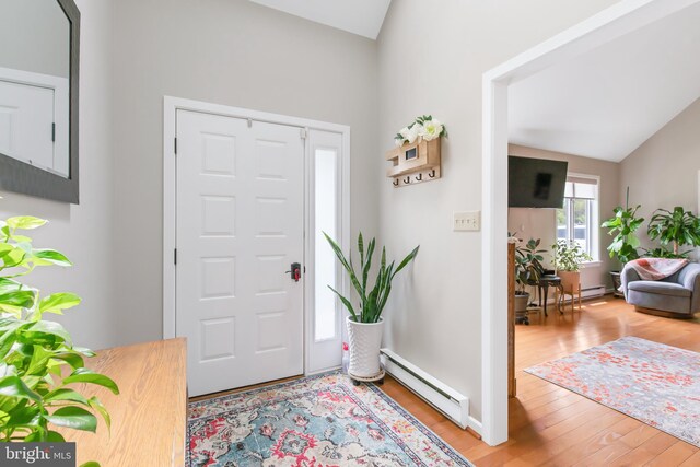 409 Hilltop Rd, Strasburg, PA 17579 - entrance foyer featuring wood-type flooring, lofted ceiling, and a baseboard heating unit