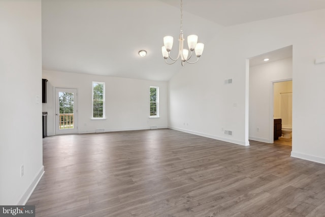 interior space with plenty of natural light, wood-type flooring, and vaulted ceiling