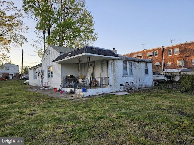 rear view of house featuring a yard