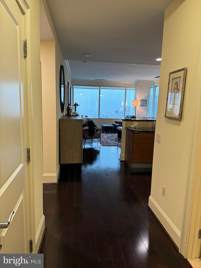 hallway with dark hardwood / wood-style floors