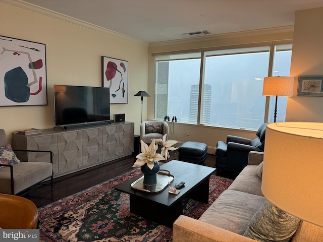 living room with ornamental molding, wood-type flooring, and plenty of natural light