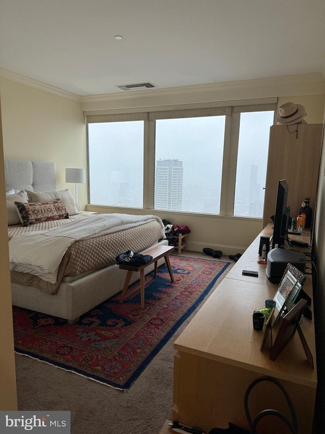 carpeted bedroom with crown molding