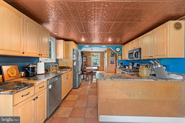 kitchen featuring appliances with stainless steel finishes, light brown cabinets, and sink