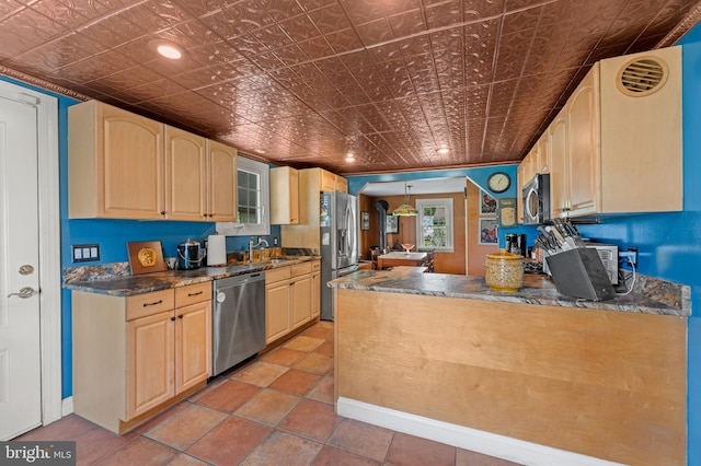 kitchen featuring kitchen peninsula, light brown cabinetry, stainless steel appliances, sink, and light tile patterned floors