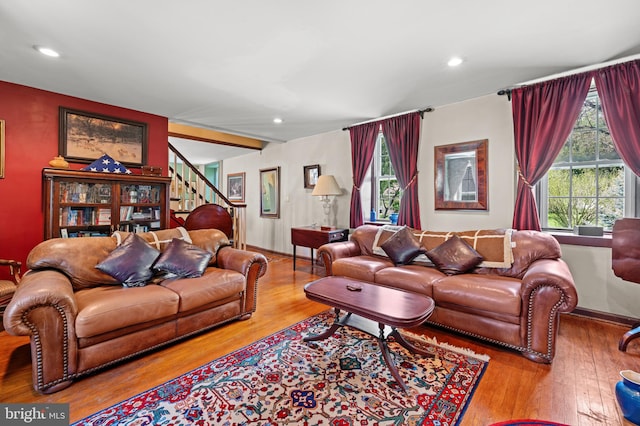 living room featuring light wood-type flooring and a healthy amount of sunlight