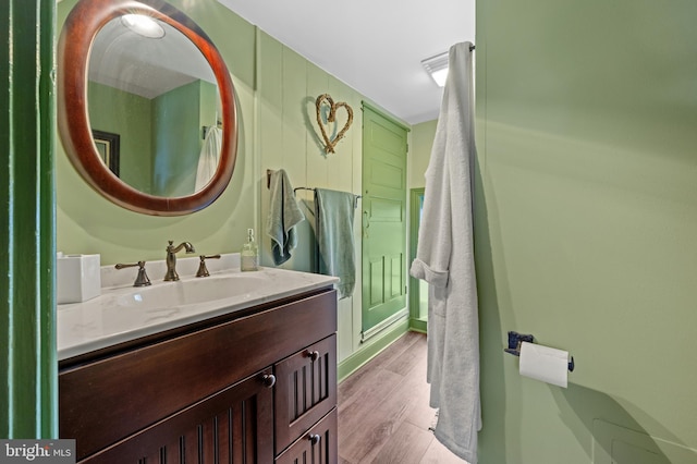 bathroom with hardwood / wood-style floors and vanity