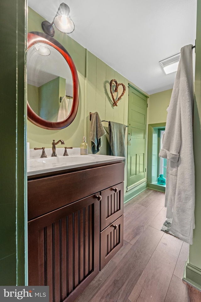 bathroom with vanity and hardwood / wood-style flooring