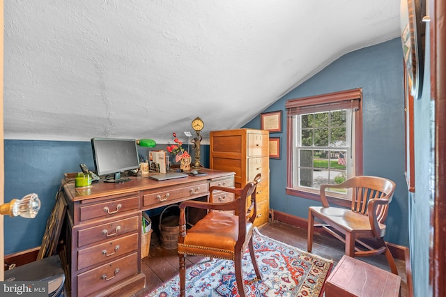 office space featuring a textured ceiling, dark wood-type flooring, and vaulted ceiling