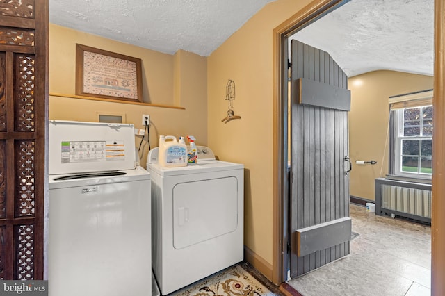 laundry room featuring radiator, a textured ceiling, and independent washer and dryer