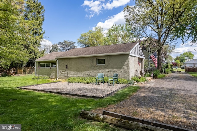 back of house with a lawn