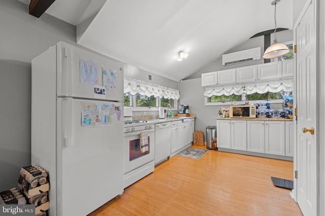 kitchen featuring white appliances, white cabinets, hanging light fixtures, light wood-type flooring, and a wall unit AC