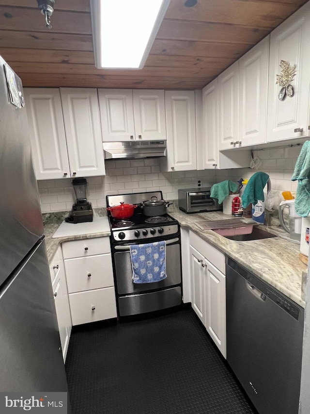 kitchen with stainless steel appliances, wooden ceiling, white cabinets, and decorative backsplash