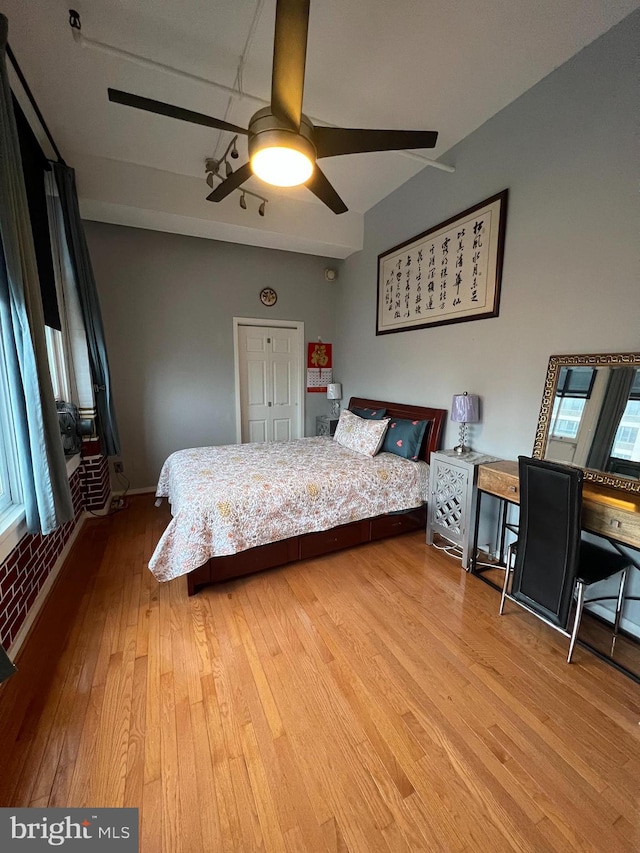 bedroom featuring a closet, hardwood / wood-style floors, and ceiling fan