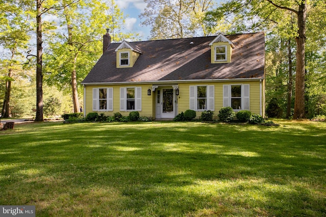 cape cod house with a front lawn