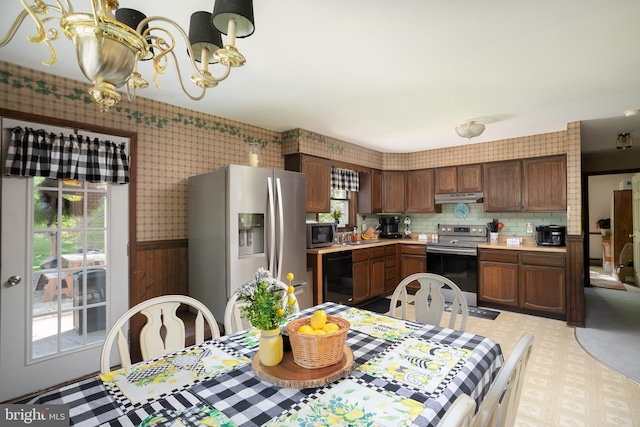 kitchen featuring tasteful backsplash, stainless steel appliances, and an inviting chandelier