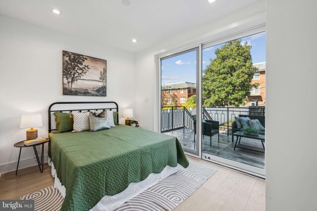 bedroom featuring hardwood / wood-style flooring and access to outside