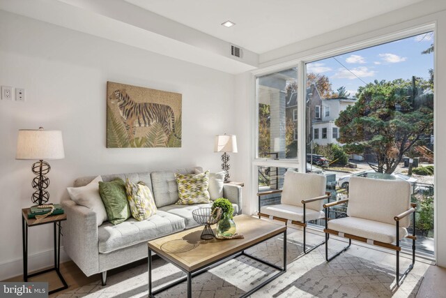 living room featuring a wealth of natural light and hardwood / wood-style flooring