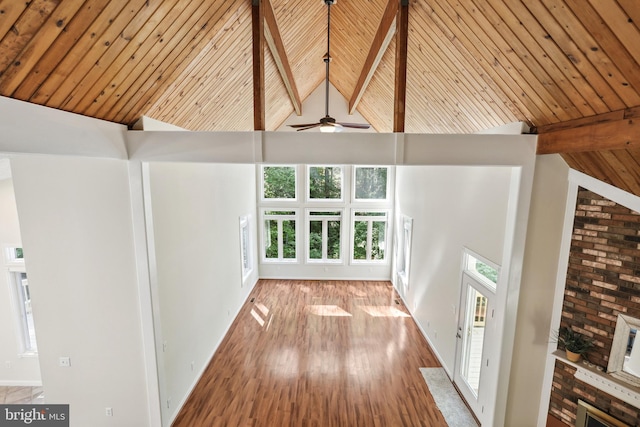 corridor with high vaulted ceiling, beamed ceiling, and light wood-type flooring