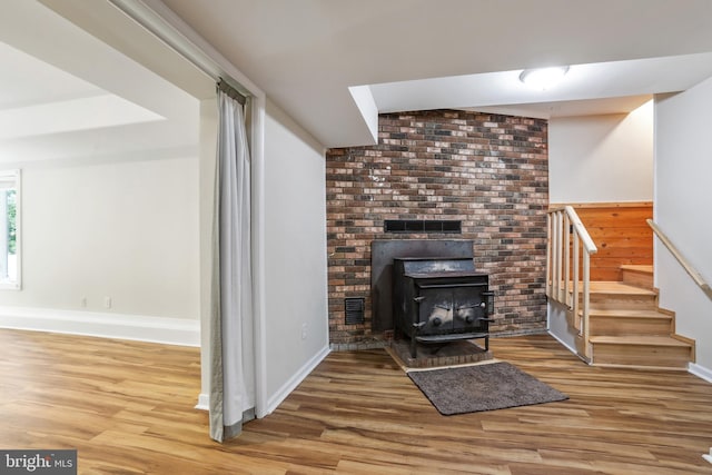 living room featuring hardwood / wood-style flooring and a wood stove