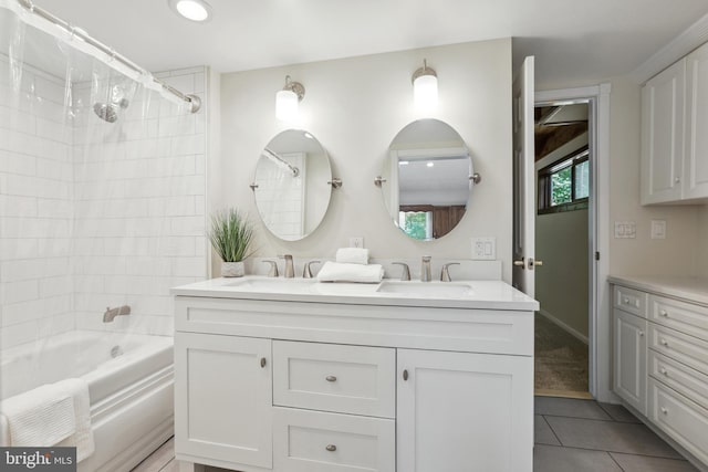 bathroom with tile patterned floors, tiled shower / bath combo, and vanity