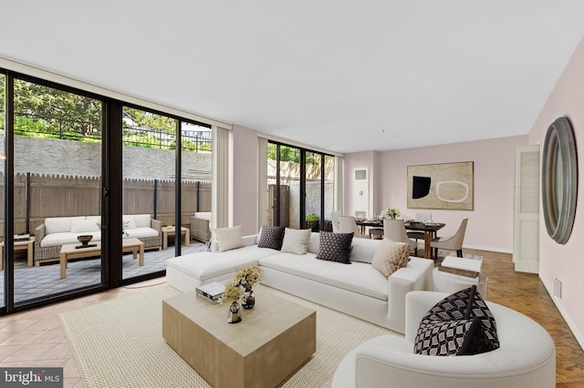 living room featuring a wall of windows and plenty of natural light