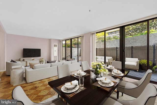 interior space with parquet flooring, floor to ceiling windows, and a healthy amount of sunlight