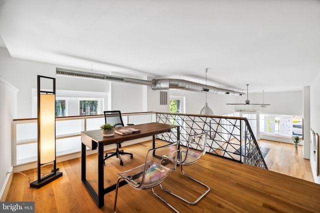 office with ceiling fan and light hardwood / wood-style floors