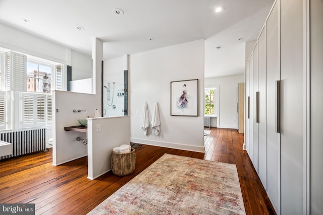 interior space with radiator and dark hardwood / wood-style floors