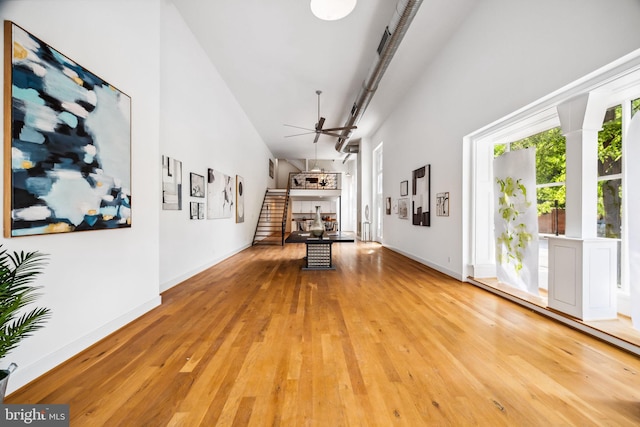 interior space with light hardwood / wood-style flooring and high vaulted ceiling