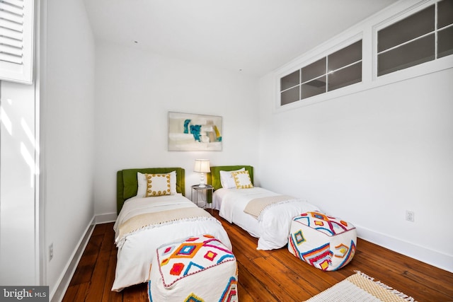 bedroom with dark hardwood / wood-style floors