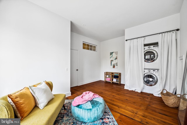 interior space featuring dark hardwood / wood-style flooring and stacked washer / drying machine