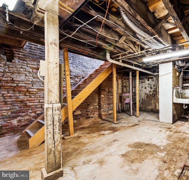 basement featuring brick wall