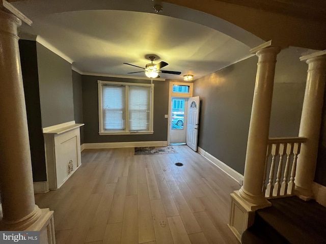 interior space featuring ornamental molding, ceiling fan, decorative columns, and light hardwood / wood-style flooring