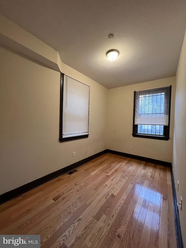 spare room featuring light wood-type flooring