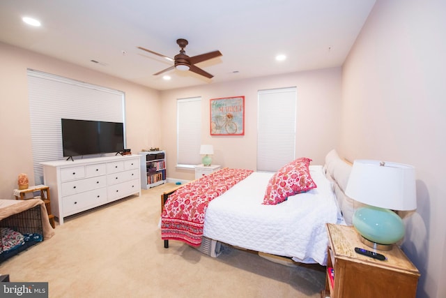 bedroom featuring light carpet and ceiling fan