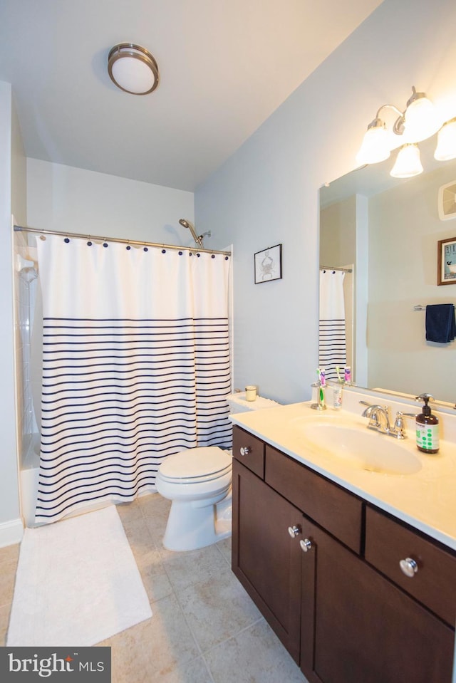 full bathroom featuring tile patterned floors, vanity, toilet, and shower / bath combo with shower curtain