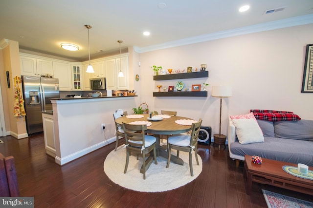 dining space featuring dark hardwood / wood-style flooring and crown molding