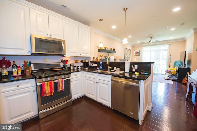 kitchen featuring white cabinetry, sink, stainless steel appliances, dark hardwood / wood-style flooring, and crown molding