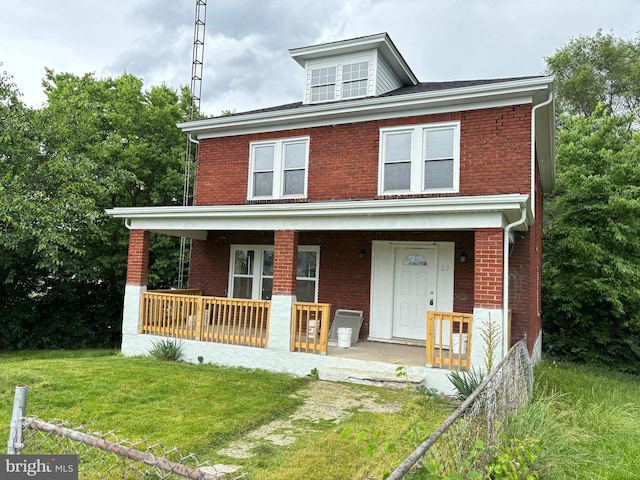 view of front of house featuring covered porch and a front yard