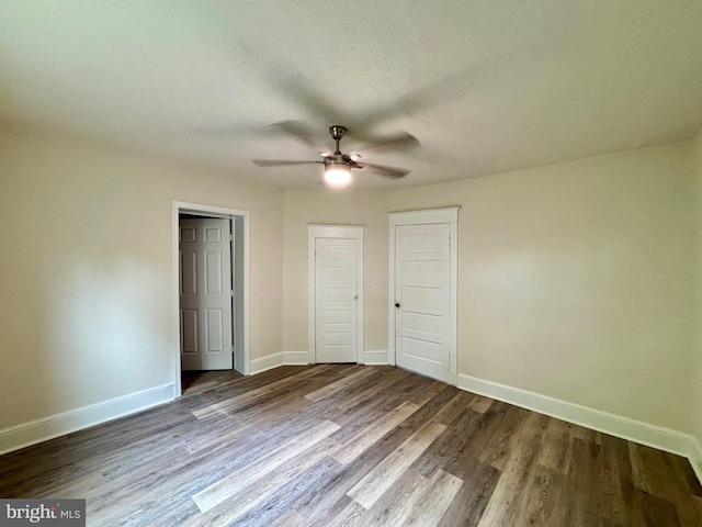 unfurnished bedroom featuring hardwood / wood-style floors and ceiling fan