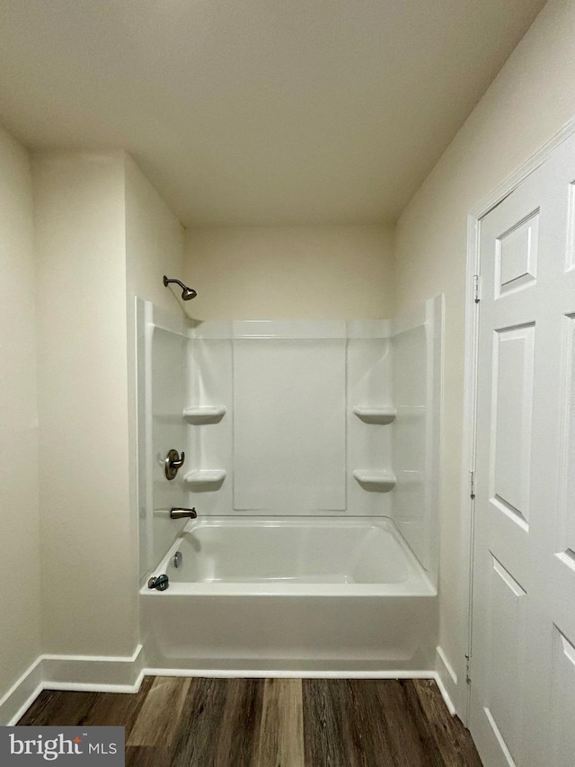 bathroom featuring hardwood / wood-style flooring and bathing tub / shower combination