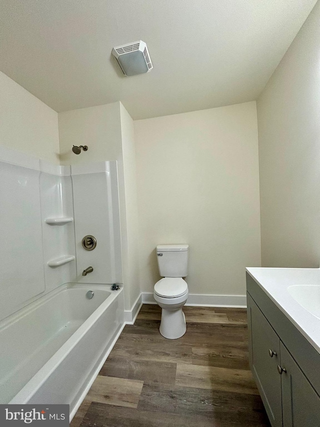 full bathroom with vanity, toilet, wood-type flooring, and bathing tub / shower combination