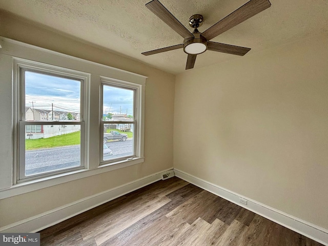 unfurnished room with ceiling fan, light hardwood / wood-style floors, and a textured ceiling